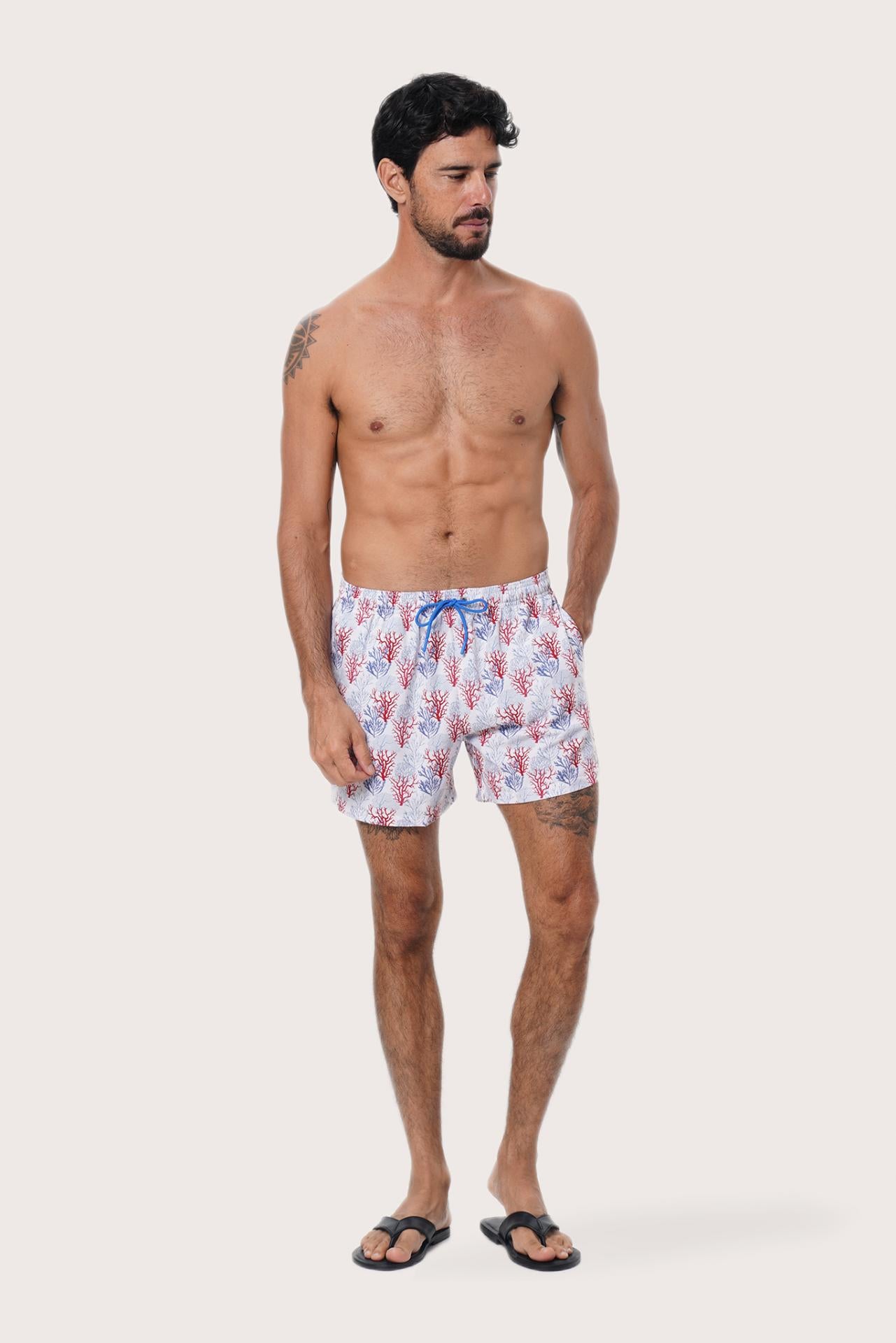 Close-up of the Coral print on the Light Blue Paco Swim Trunk by By The Sea Bali