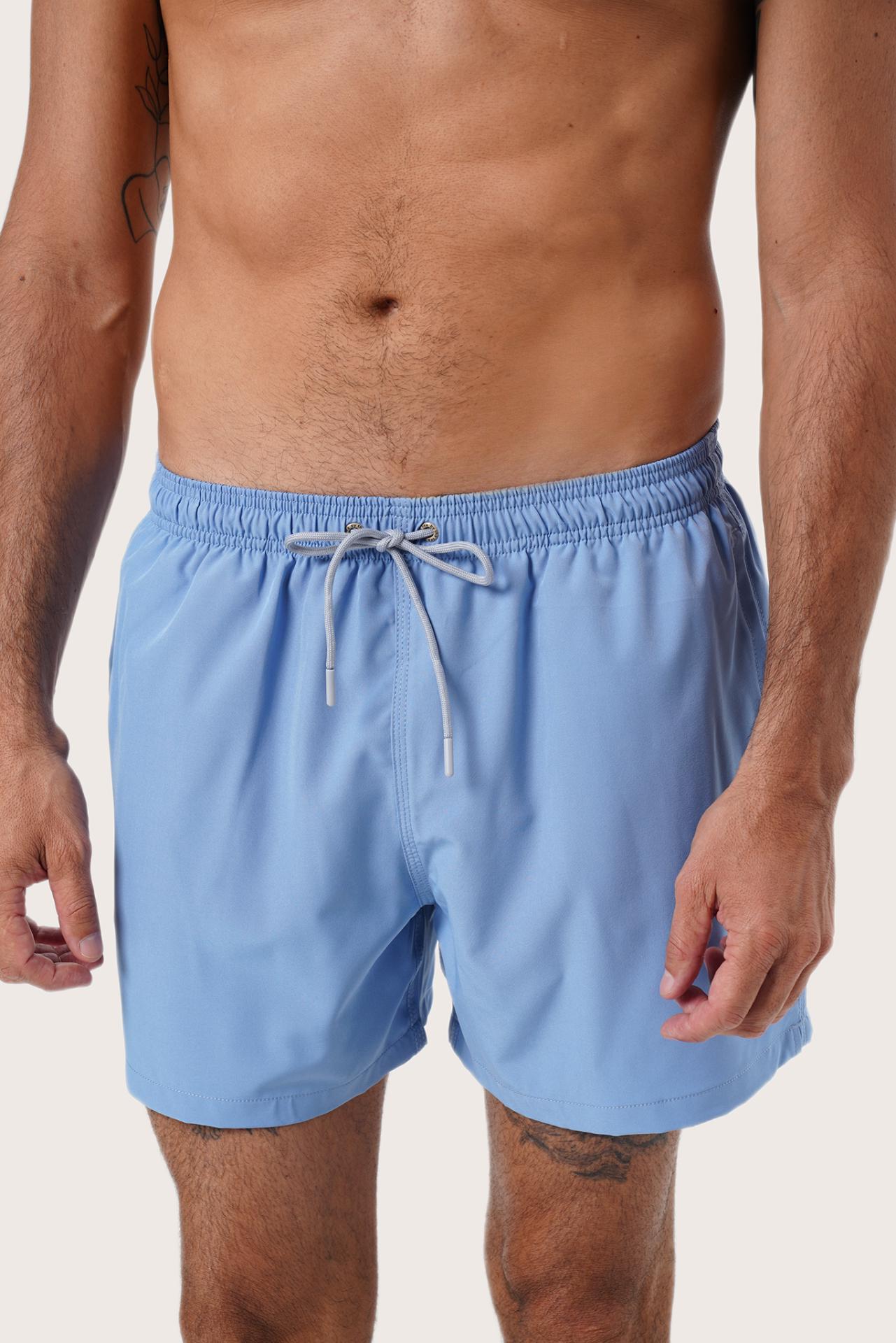 Men's beachwear styling featuring the Paco Swim Trunk in Light Blue by By The Sea Bali