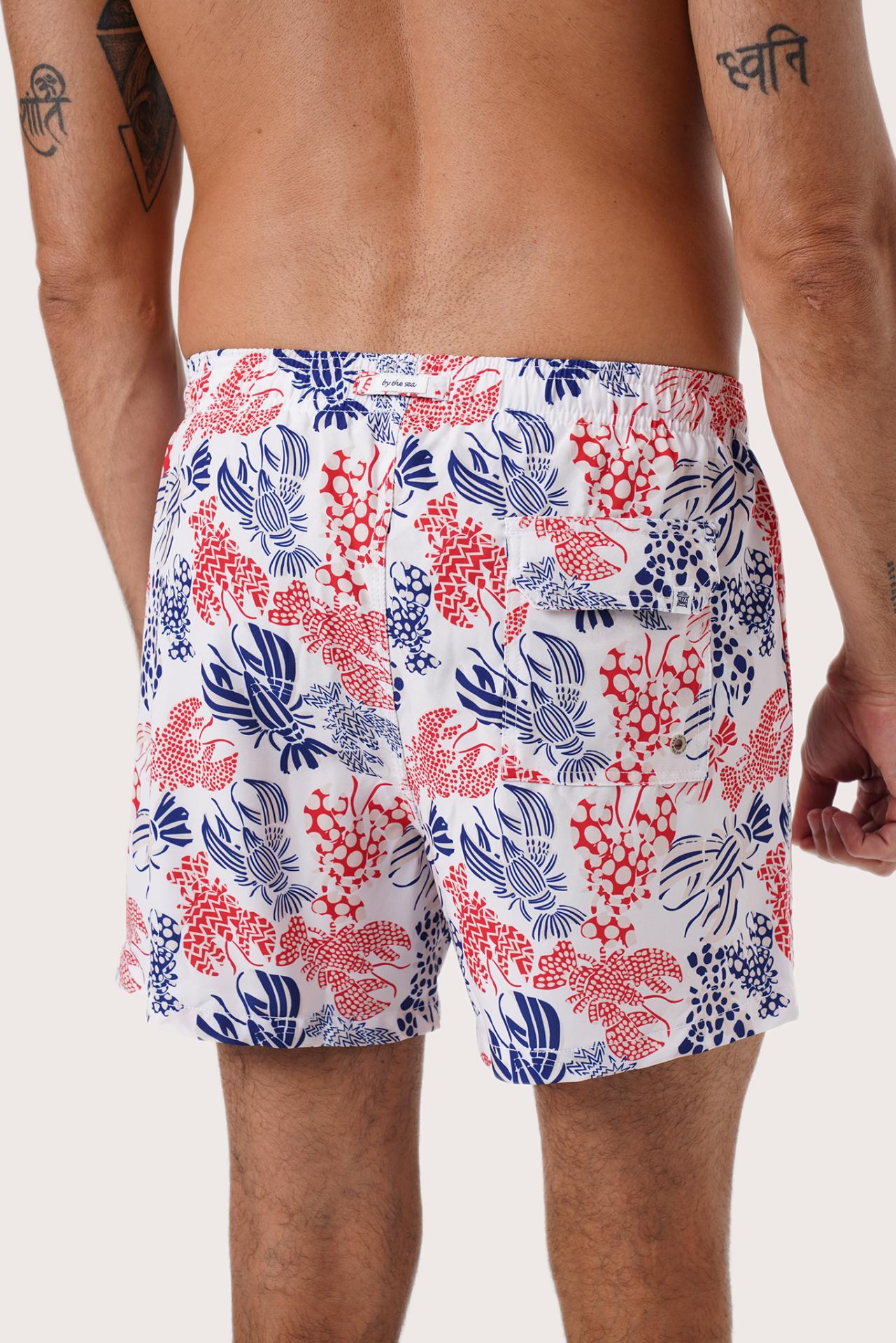 Men's beachwear styling featuring the Paco Swim Trunk in Lobster and Sea White by By The Sea Bali