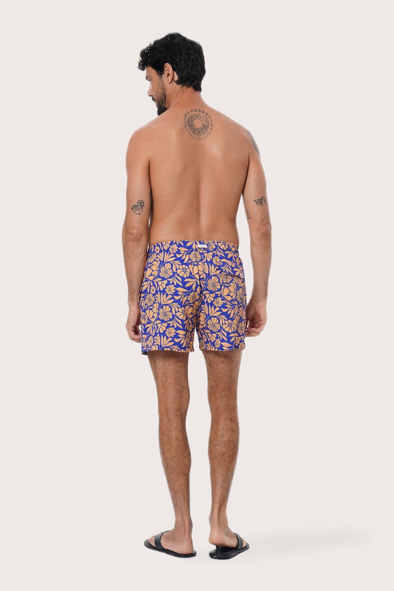 Side view of the Paco Swim Trunk in Spring Flora Orange with elastic waistband detail by By The Sea Bali