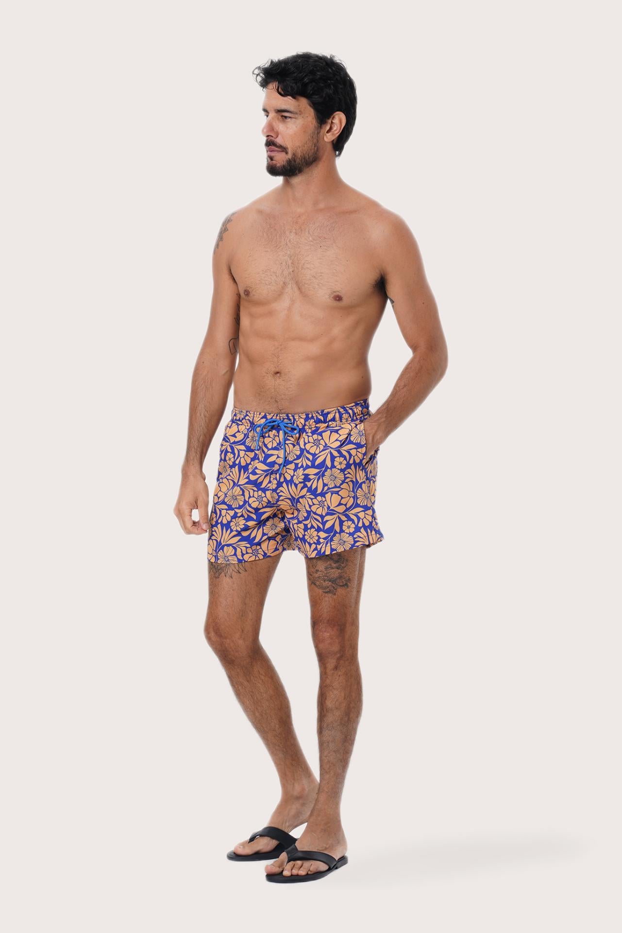 Close-up of the Spring Flora Orange floral print on the Paco Swim Trunk by By The Sea Bali