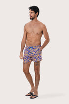 Close-up of the Spring Flora Orange floral print on the Paco Swim Trunk by By The Sea Bali