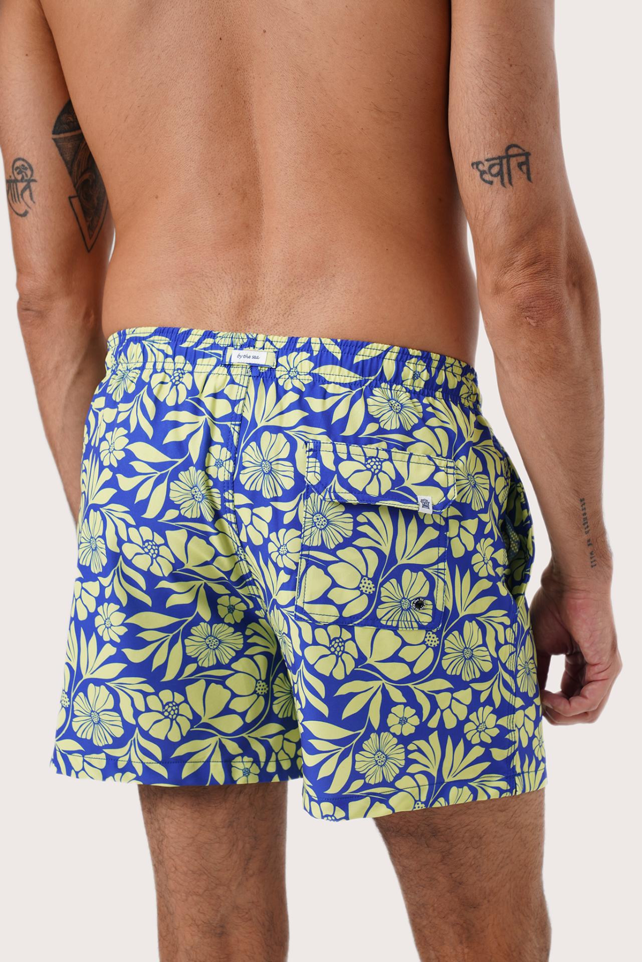 Full view of the Spring Flora Yellow Lime Paco Swim Trunk — easy poolside dressing by By The Sea Bali