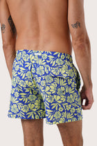 Full view of the Spring Flora Yellow Lime Paco Swim Trunk — easy poolside dressing by By The Sea Bali