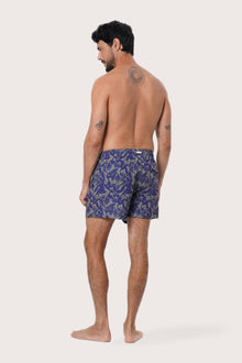 Men's beachwear styling featuring the Paco Swim Trunk in Tropic Garde Blue by By The Sea Bali