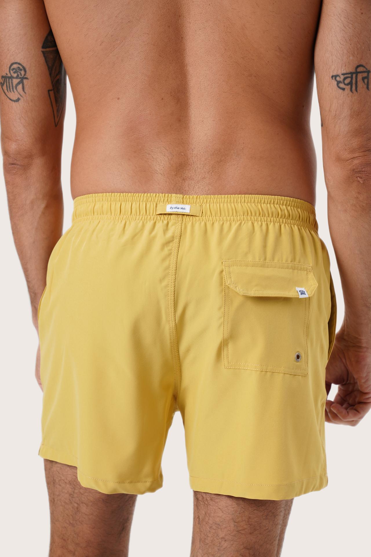 Men's beachwear styling featuring the Paco Swim Trunk in Yellow by By The Sea Bali