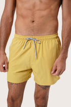 Side view of the Paco Swim Trunk in Yellow with elastic waistband detail by By The Sea Bali