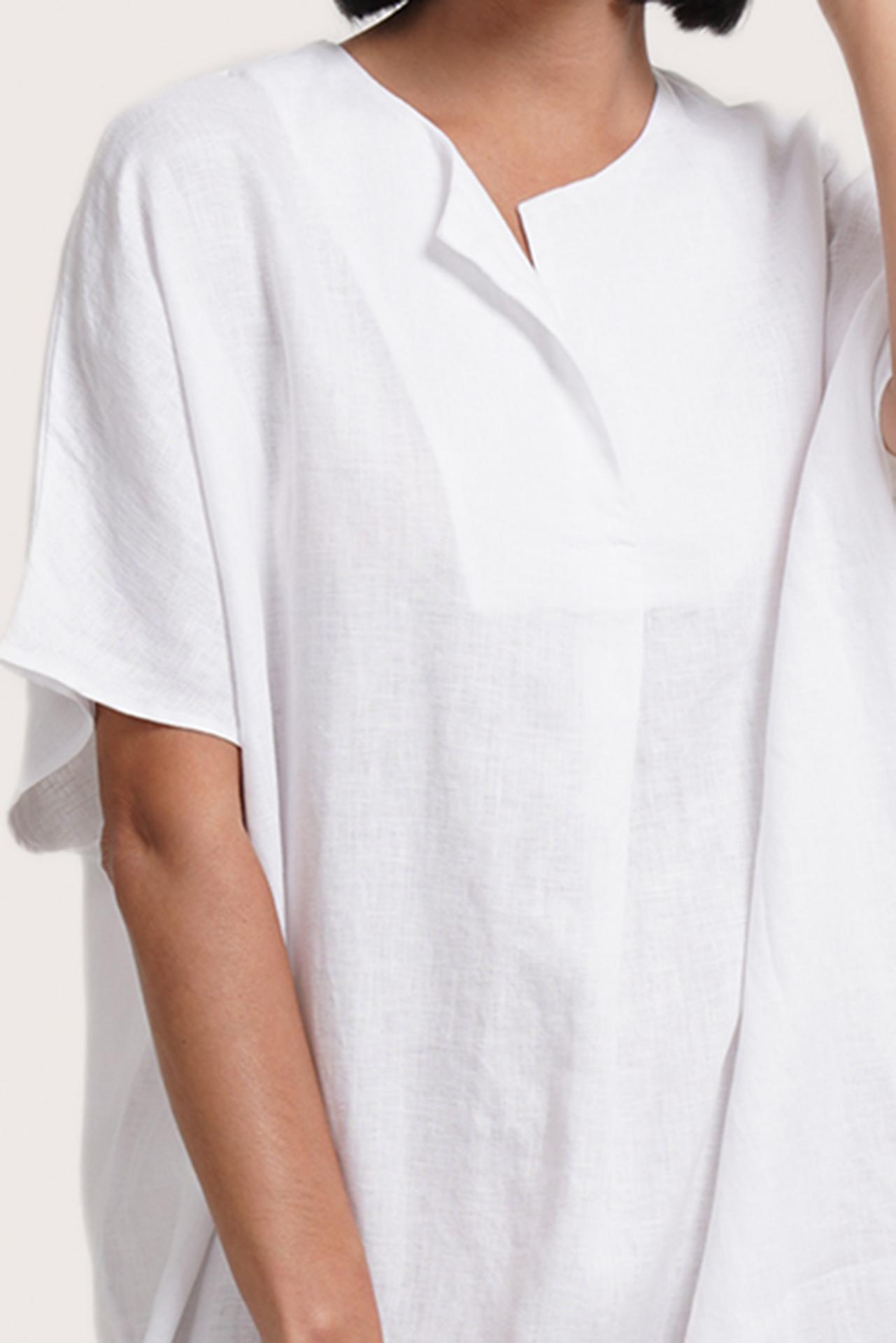 Close up detail of the Padar Linen Dress White highlighting craftsmanship and design features