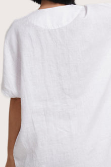 Close up detail of the Padar Linen Dress White highlighting craftsmanship and design features