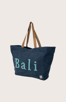 Angled view of the navy Paradise tote bag showcasing its spacious design