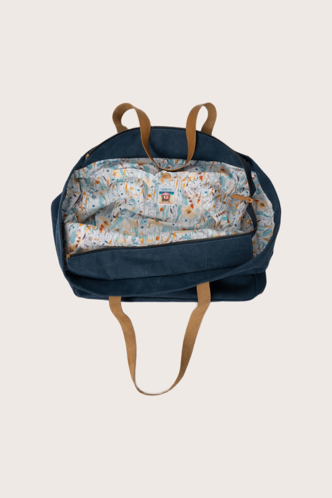 Top view of the navy Paradise tote bag showing the printed interior lining