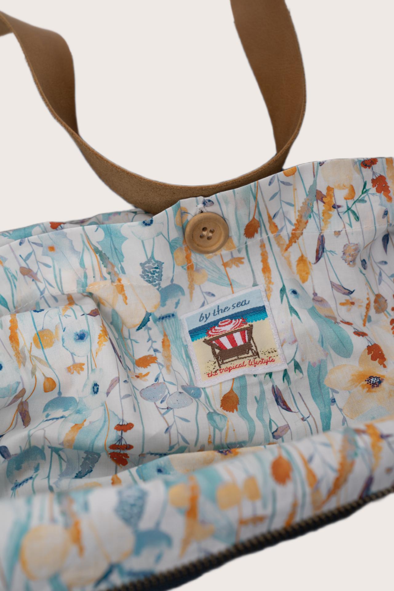 Close-up of the floral interior lining inside the navy Paradise tote bag