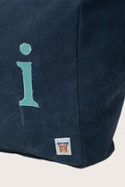 Close-up of the embroidered Bali logo and premium craftsmanship on the navy Paradise tote bag