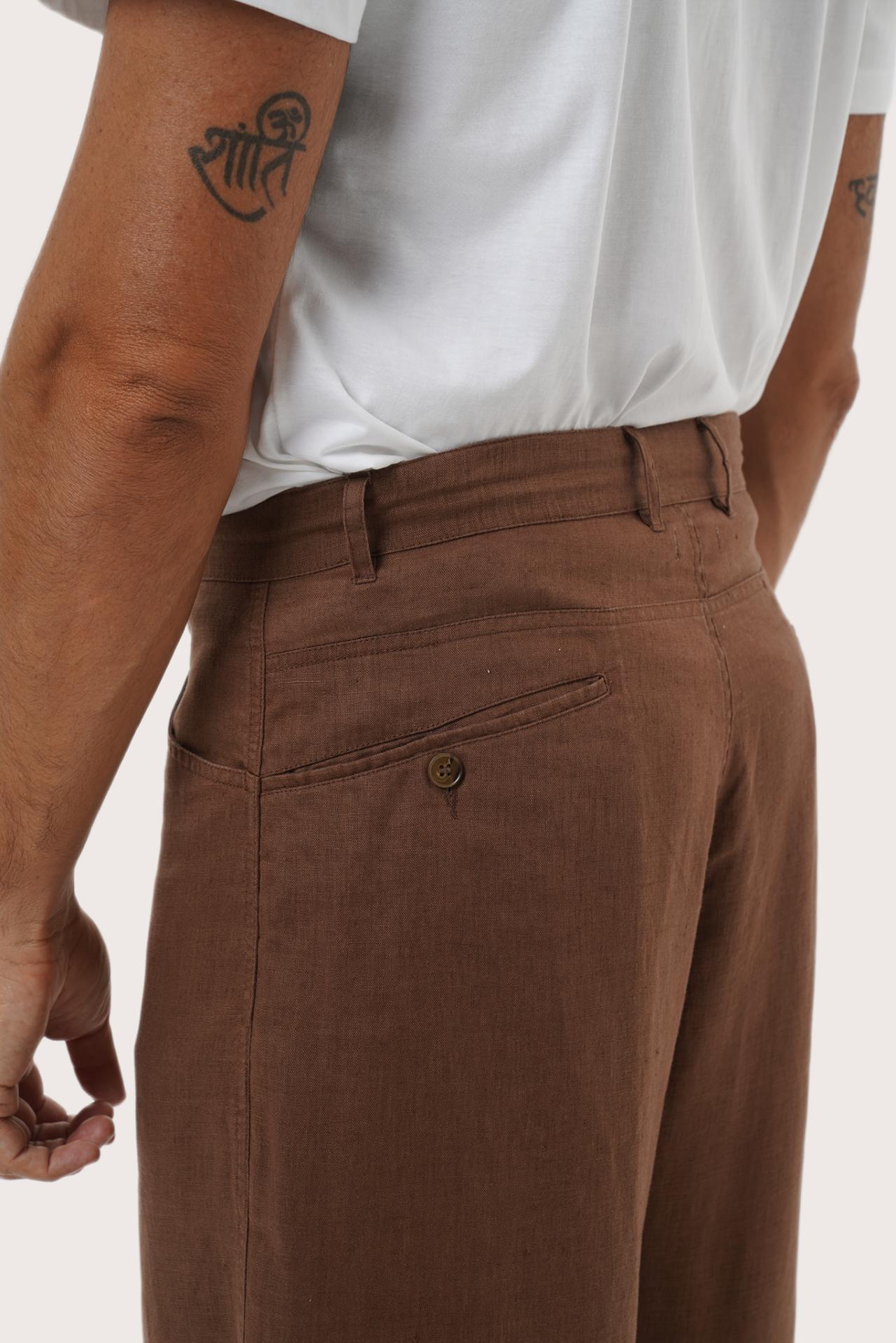 Close-up detail of the Parha Linen Pant in Brown highlighting the slash pocket and refined button front by By The Sea Bali