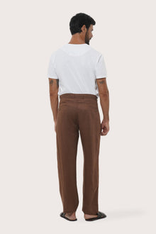 Parha Linen Pant in warm Brown showcasing the unique welt back pocket and natural linen drape by By The Sea Bali