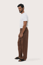 Side profile of the Parha Linen Pant in Brown by By The Sea Bali, tailored in breathable 100% linen