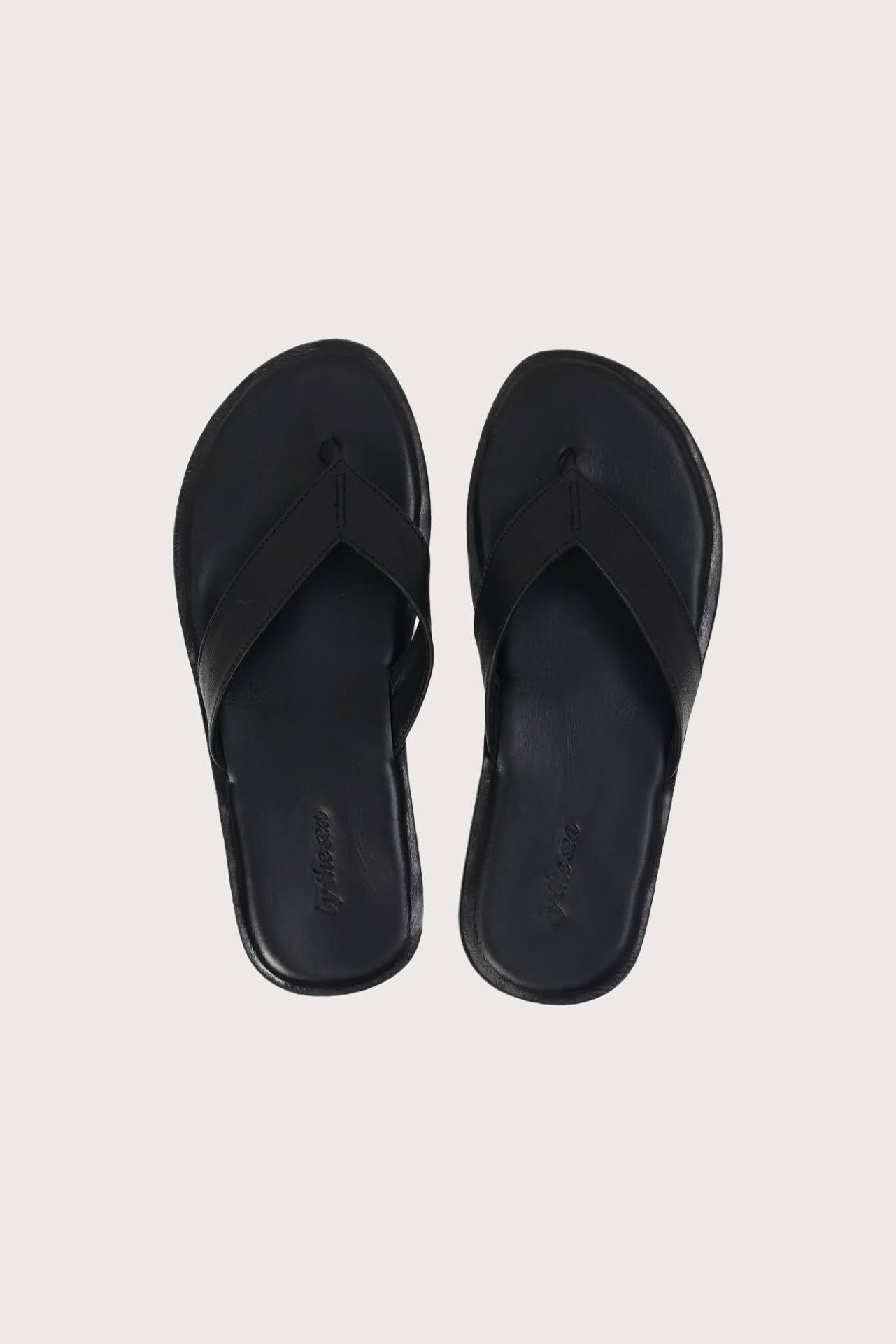 Paros leather sandals in nero shown in a global view highlighting their full silhouette and refined resort design