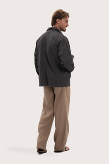 Back view of the dark brown cotton jacket with a relaxed and contemporary silhouette