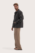Side profile of the dark brown cotton jacket showcasing its comfortable fit and clean lines