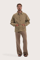 Model wearing the khaki cotton Parth jacket by By The Sea Bali