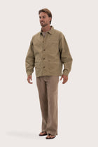 Side profile of the khaki cotton jacket showcasing its comfortable fit and clean lines