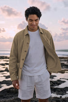 Men wearing By the sea jacket on the white T-shirt and white Liinen shorts in the beach in Bali  pererenan