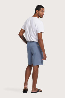 Back view of the light blue bermuda shorts with a relaxed and tailored silhouette