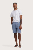 Model wearing the light blue Paulo bermuda shorts by By The Sea Bali