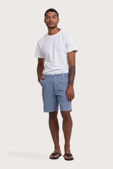 Model wearing the light blue Paulo bermuda shorts by By The Sea Bali