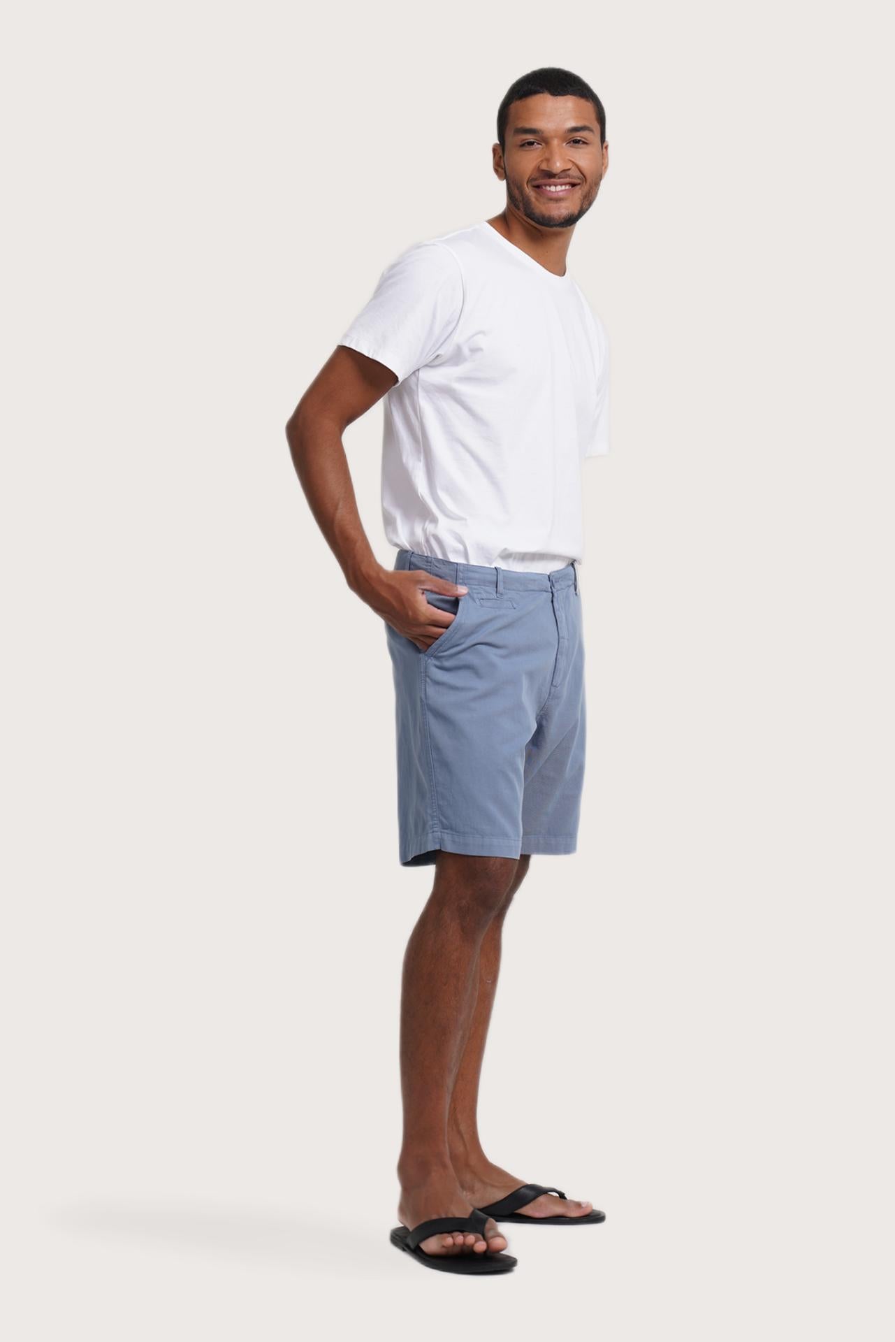 Side profile of the light blue bermuda shorts showcasing their effortless fit
