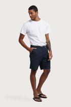 Model wearing the navy Paulo bermuda shorts by By The Sea Bali