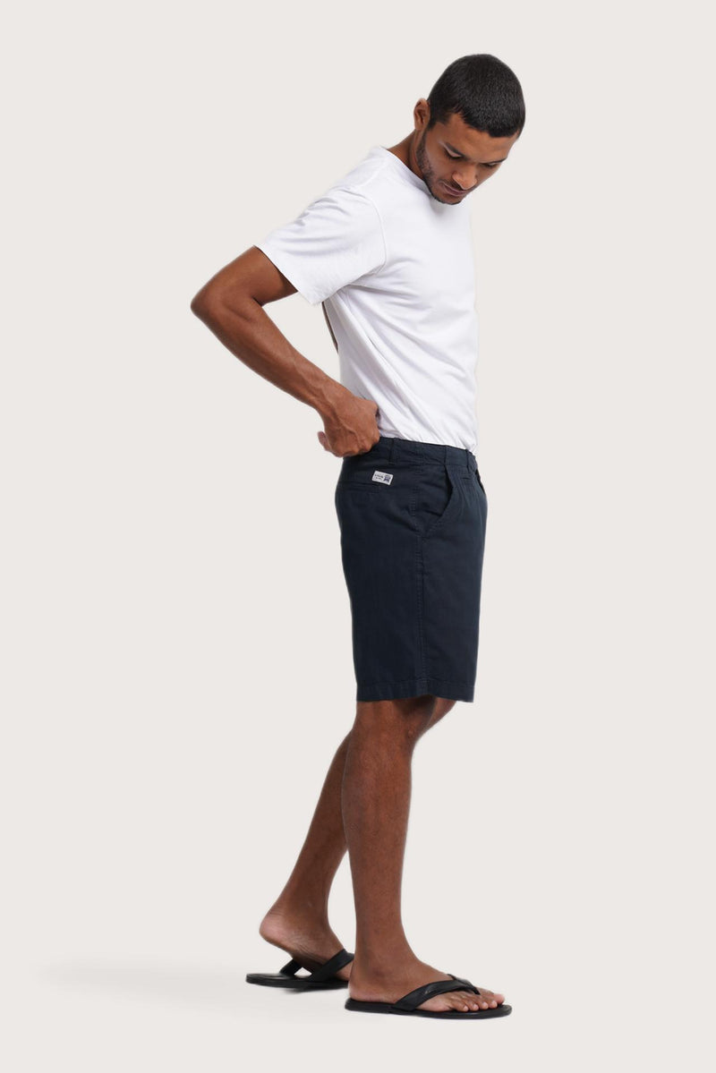 Side profile of the navy bermuda shorts showcasing their effortless fit