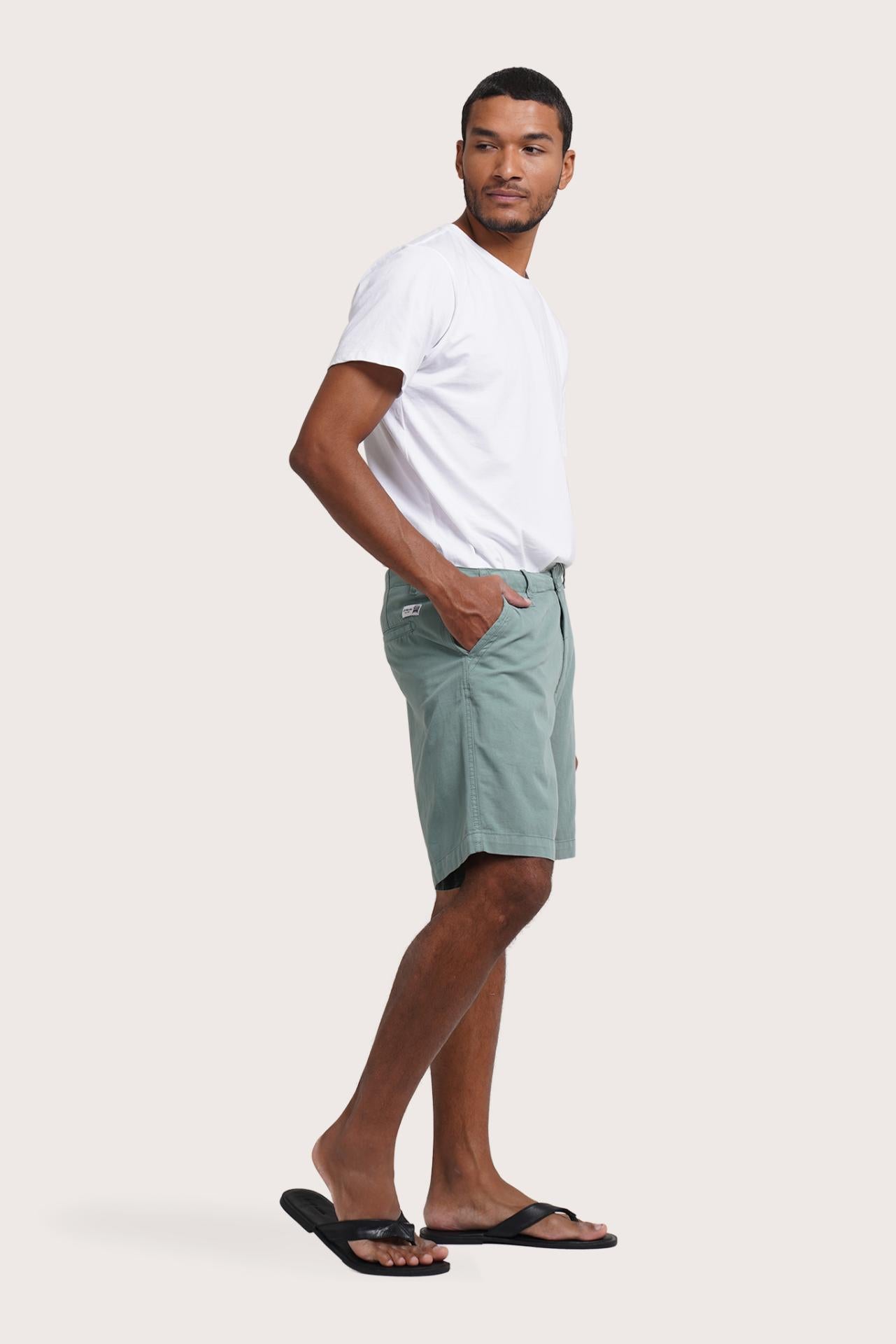Model wearing the sage Paulo bermuda shorts by By The Sea Bali
