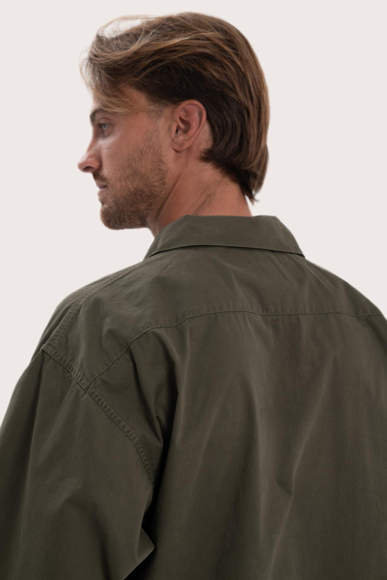 Detailed back view highlighting the relaxed silhouette and cotton craftsmanship