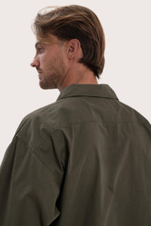 Detailed back view highlighting the relaxed silhouette and cotton craftsmanship
