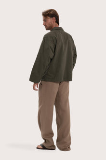 Back view of the dark brown cotton outerwear with a relaxed and contemporary silhouette
