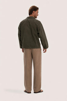 Back view of the dark brown cotton outerwear with a relaxed and contemporary silhouette
