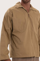 Close-up of the cotton fabric texture and refined detailing on the light brown outerwear