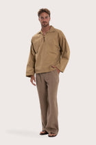 Side profile of the light brown cotton outerwear showcasing its comfortable fit and effortless drape