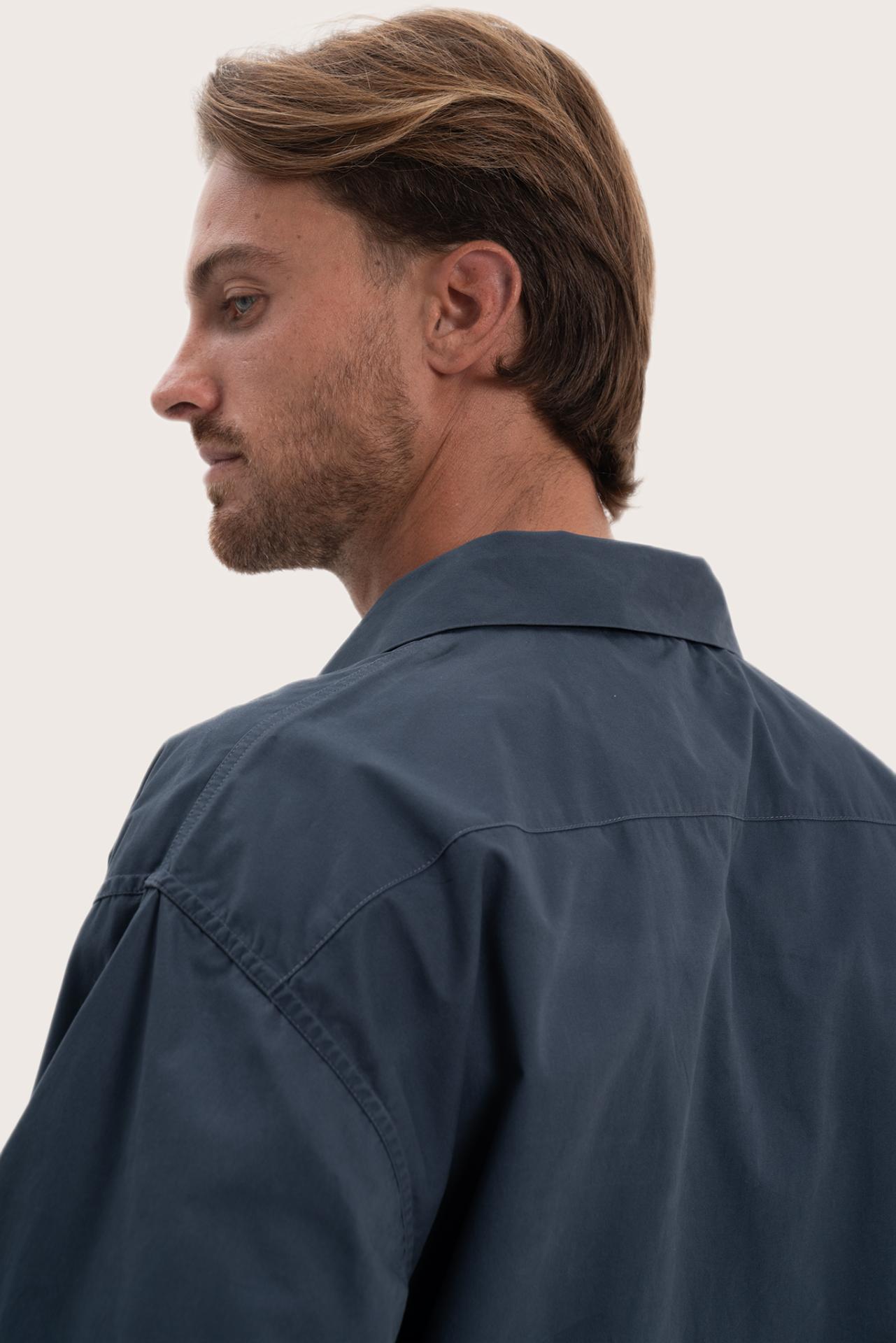 Detailed back view highlighting the relaxed silhouette and cotton craftsmanship