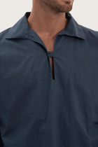 Close-up of the cotton fabric texture and refined detailing on the navy outerwear