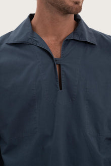Close-up of the cotton fabric texture and refined detailing on the navy outerwear