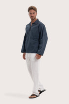 Side profile of the navy cotton outerwear showcasing its comfortable fit and effortless drape