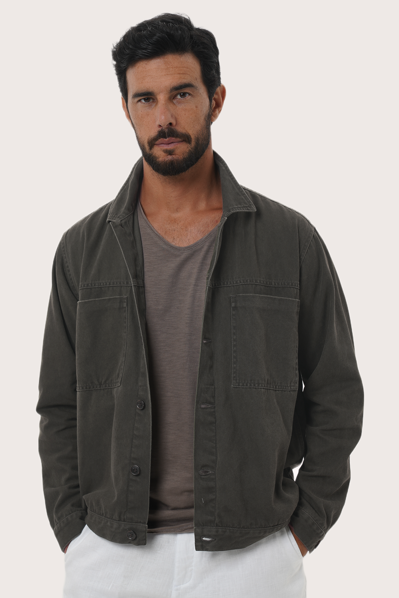 Close-up of the cotton fabric texture and refined detailing on the grey brown jacket