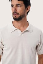 Close-up detail of the fine knit texture on the By The Sea Bali Rado cream cotton-knit polo shirt