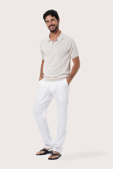 Side profile of the By The Sea Bali Rado cream cotton-knit polo shirt showing its tailored relaxed fit