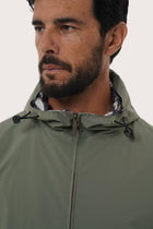 Close-up of the polyester fabric texture and hoodie jacket detailing in army green