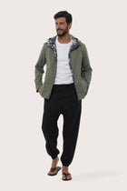 Model wearing the army green Raiga hoodie jacket by By The Sea Bali