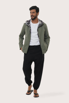 Model wearing the army green Raiga hoodie jacket by By The Sea Bali