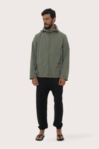 Model wearing the army green Raiga hoodie jacket by By The Sea Bali